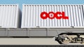 Railway transportation of containers with Orient Overseas Container Line OOCL logo. Editorial 3D rendering Royalty Free Stock Photo