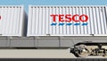 Railway transportation of containers with Tesco logo. Editorial 3D rendering