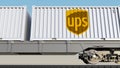 Railway transportation of containers with United Parcel Service UPS logo. Editorial 3D rendering