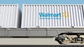 Railway transportation of containers with Walmart logo. Editorial 3D rendering