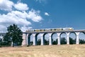 Railway viaduct in Boleslawiec with a Koleje Dolnoslaskie  Lower Silesian Railways train. Royalty Free Stock Photo
