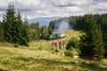 Railway viaduct bridge in Ukraine with the steam train