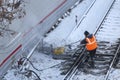 Railway worker cleans a railway track