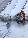 Railway worker cleans a railway track