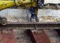 Railway workers bolting track rail. Detail worker with Light portable sleepers drilling machine Royalty Free Stock Photo