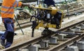 Railway workers bolting track rail. Detail worker with mechanical bolting wrench Royalty Free Stock Photo