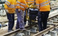 Railway workers bolting track rail. Detail worker with mechanical bolting wrench Royalty Free Stock Photo