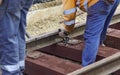 Railway workers bolting track rail. Detail worker with mechanical bolting wrench Royalty Free Stock Photo