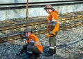 Railway workers connect ground wire