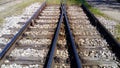 Railways. Rails and sleepers on the ground near the station. Long way concept. Interlacing of tracks, railway arrows Royalty Free Stock Photo