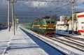 Railways Train passes by the city platform Ramenskoye in the Moscow Region in the winter Royalty Free Stock Photo