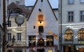 evening in medieval city old houses ruffles blurred light street clock in Tallinn old town Royalty Free Stock Photo