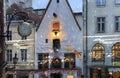 Rainy evening in medieval city old houses ruffles blurred light street clock in Tallinn old town Royalty Free Stock Photo