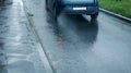 Rain, autumn street background - car rides on the road, puddle a Royalty Free Stock Photo