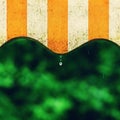 Rain. Awning on a balcony and drops of water on a natural colorful background during a spring day. Royalty Free Stock Photo