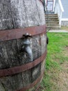 Modern wooden rain barrel with brass spigot used for water conservation and makes an attractive landscaping feature. Royalty Free Stock Photo