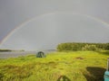 After the rain, a bright rainbow stretches across the Ob River Royalty Free Stock Photo
