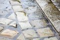 Rain in the city - puddles on the cobblestone street pavement -