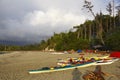 Rain clouds above the beach, kayaks in the foreground