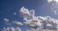 Rain clouds buildup panorama in blue sky.