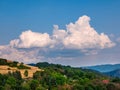 Rain clouds - Cumulonimbus - forming in the blue sky over hilly landscape Royalty Free Stock Photo