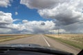 View through windshield of prairie highway