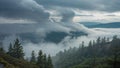 Rain clouds passing over pine ridge with fog sinking into valley behind Royalty Free Stock Photo