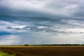 Rain clouds and plowed field. Royalty Free Stock Photo