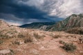 Rain is coming. Landscape with mountain range, dark clouds and rain streaks in the distance. Royalty Free Stock Photo