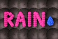 Rain concept. Rain letters arranged of umbrella on dark background. Bad weather, nobody