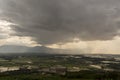 Rain curtaining a view of the mountains.Rain storm over Rice fie Royalty Free Stock Photo