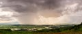 Rain curtaining a view of the mountains.Rain storm over Rice fie Royalty Free Stock Photo