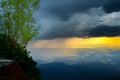 Rain and the dark clouds in the distance view from a mountain top, evening sunset, and dramatic heavy thunderstorm clouds side Royalty Free Stock Photo