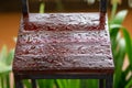 Rain-drenched wooden chair in a restaurant, a restaurant waiting to return to open. Concept, a chair in the shop with no one