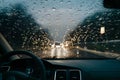 Rain drizzle on windshield in evening, driving in bad weather