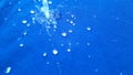 Rain drop on blue surface ,Water splash like a crown ,Water splash in crown shape and falling drop Royalty Free Stock Photo