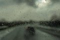 Rain drop on the cars windscreen . Abstract traffic in raining day. Road view through car window with rain . Royalty Free Stock Photo