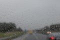 Rain drop on the cars windscreen . Abstract traffic in raining day. Road view through car window with rain . Royalty Free Stock Photo