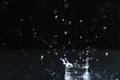 Rain drop falling down into puddle Royalty Free Stock Photo