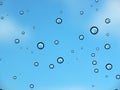 Rain drop on glass against blue sky and few cloud Royalty Free Stock Photo