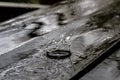 Rain drop splash in wooden floor bouncing and shaping a water crown Royalty Free Stock Photo