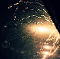 Rain drop on window, traffic light at night make bokeh Royalty Free Stock Photo