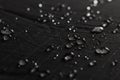 Rain droplets on black waterproof fabric