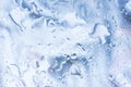 Rain droplets. Spilled water drops on glass, natural blue background. Royalty Free Stock Photo