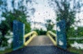 Rain droplets on the surface of car glass with blurred green nature and bridge background through window glass of car covered by r Royalty Free Stock Photo