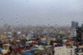 Rain droplets on a window with a city view Royalty Free Stock Photo