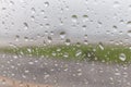 Rain drops on airplane window glass and blurred airport runway i Royalty Free Stock Photo