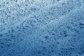 Rain drops on blue color metal car surface. Royalty Free Stock Photo