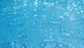 Rain drops on the blue glass bokeh background, shiny raindrops on a glass surface, water drops in a swimming pool closeup Royalty Free Stock Photo