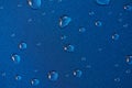 Rain drops on blue metal surface Royalty Free Stock Photo